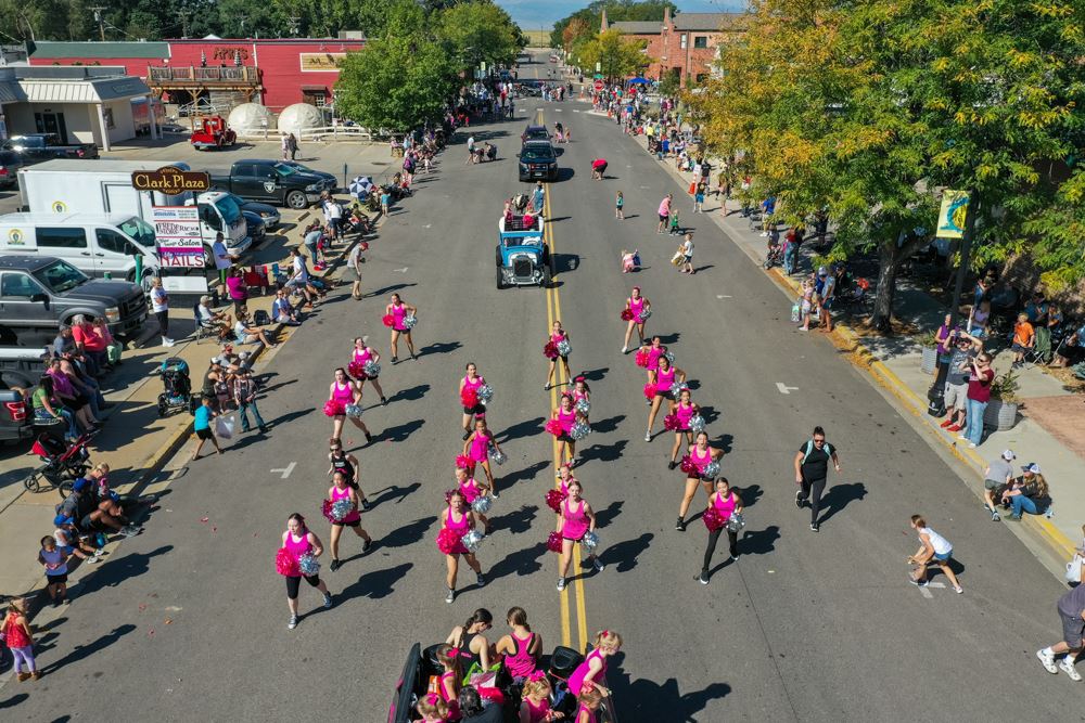An aerial image of Miners Day Parade with a squad cheerleaders wearing pink in formation