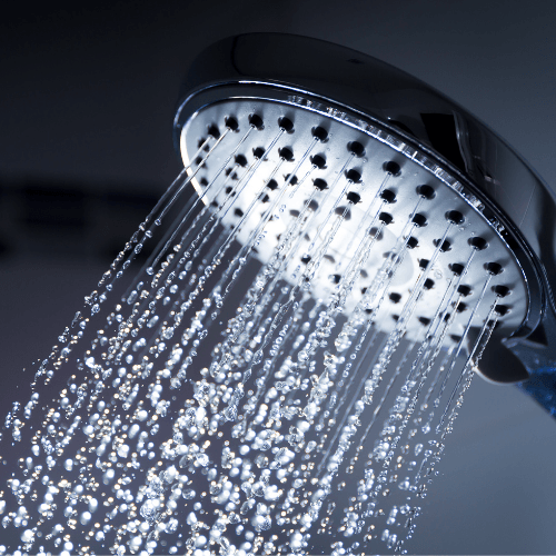 Close-up of water flowing in steady streams from a modern showerhead.