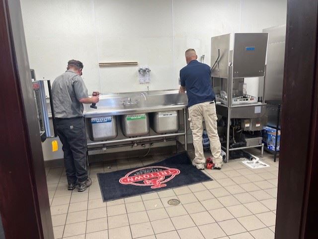 Men working on an industrial kitchen