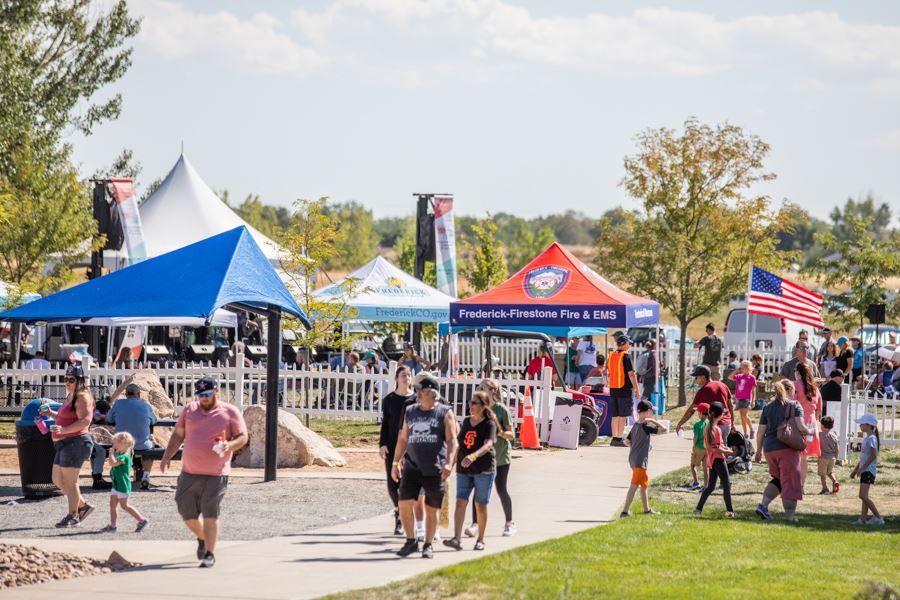 Attendees walking and exploring booths at Miners Day event.